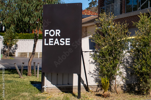 For lease sign on a black display outside of a resedential building in Australia. Investment property real estate photo