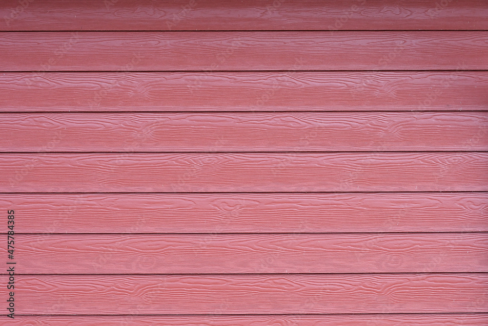 Natural red background from a simple fence made of old rough wooden planks with the texture of unsmiled wood. Natural red background from a simple fence made of old rough wooden planks with the texture of unsmiled wood.