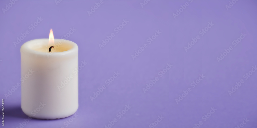 candle with flame, violet background space for text candle with flame, violet background space for text