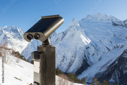 Photo Binoculars on the observation deck in the high, snowy mountains.