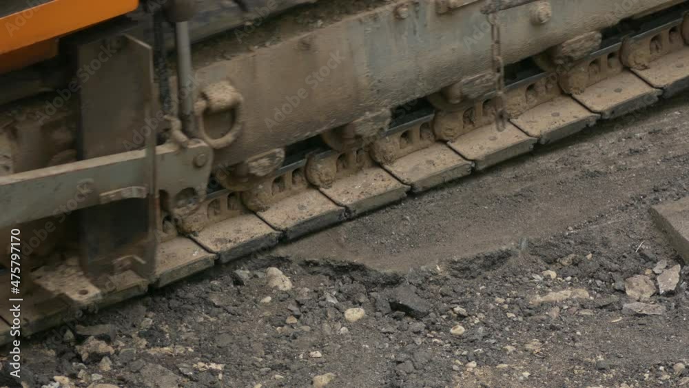 Tracked crawler asphalt paver constructs a new asphalt pavement of the roadway.
Unmodified camera color. Tracked crawler asphalt paver constructs a new asphalt pavement of the roadway.
Unmodified camera color.