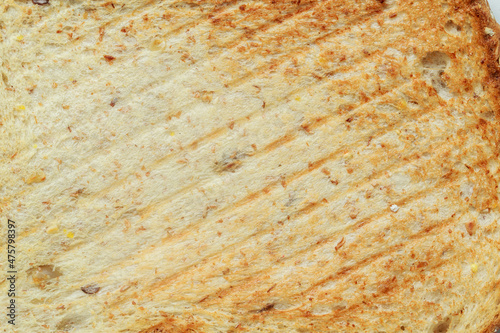 Close up roasted bread background texture. Macro photo top view.