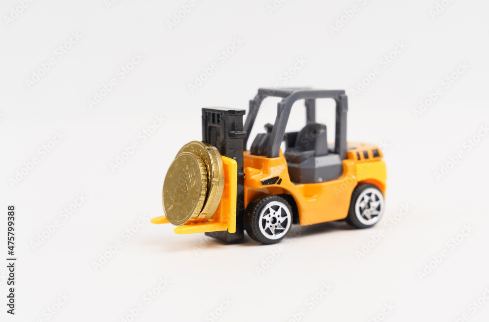 A toy loader transports coins. Isolated on white background. A toy loader transports coins. Isolated on white background.