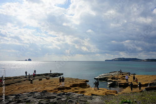 a marvelous rock coast and distant island in the sunlight