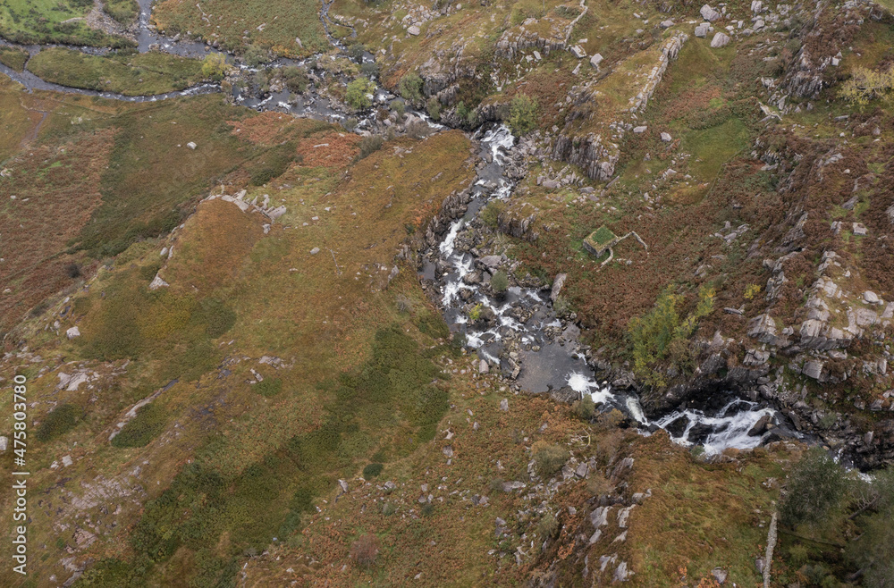 Aerial view of flying drone Stunning landscape image of view down to Ogwen falls and river in Snowdoina National Park in Autumn