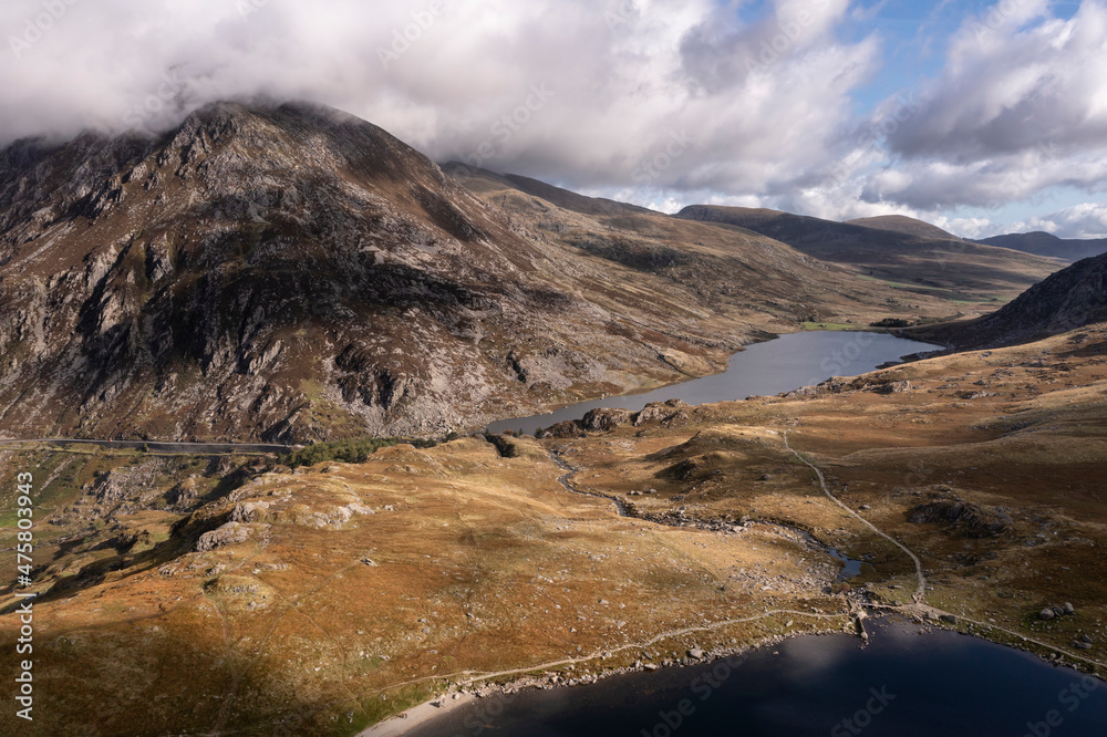 Aerial view of flying drone Epic Autumn Fall landscape image of view along Ogwen vslley in Snowdonia National Park with moody sky and mountains Aerial view of flying drone Epic Autumn Fall landscape image of view along Ogwen vslley in Snowdonia National Park with moody sky and mountains