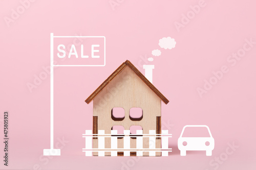 House for sale. Real estate purchase and sale concept. Real estate services. Bargain home purchase. Small wooden house on a pink background. photo