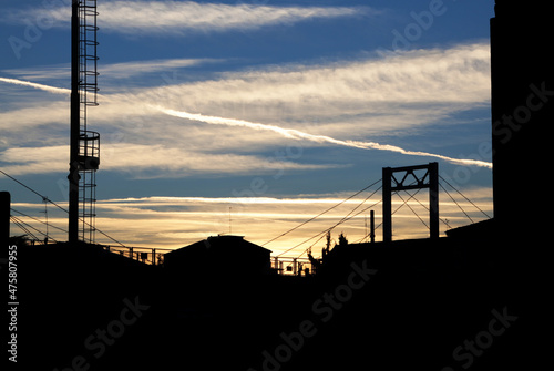 Bridge and city silhouette under sunset light