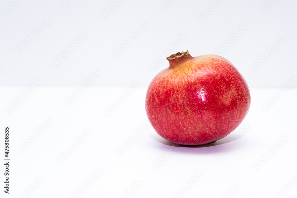Red ripe pomegranate, fruit on a white background. Isolated item and copy space. Red ripe pomegranate, fruit on a white background. Isolated item and copy space.
