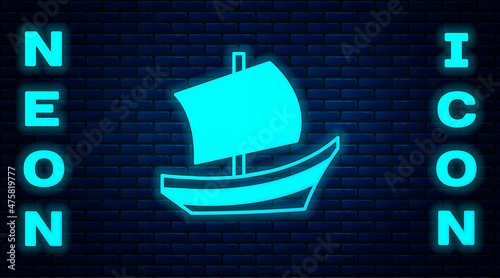 Glowing neon Egyptian ship icon isolated on brick wall background. Egyptian papyrus boat. Vector