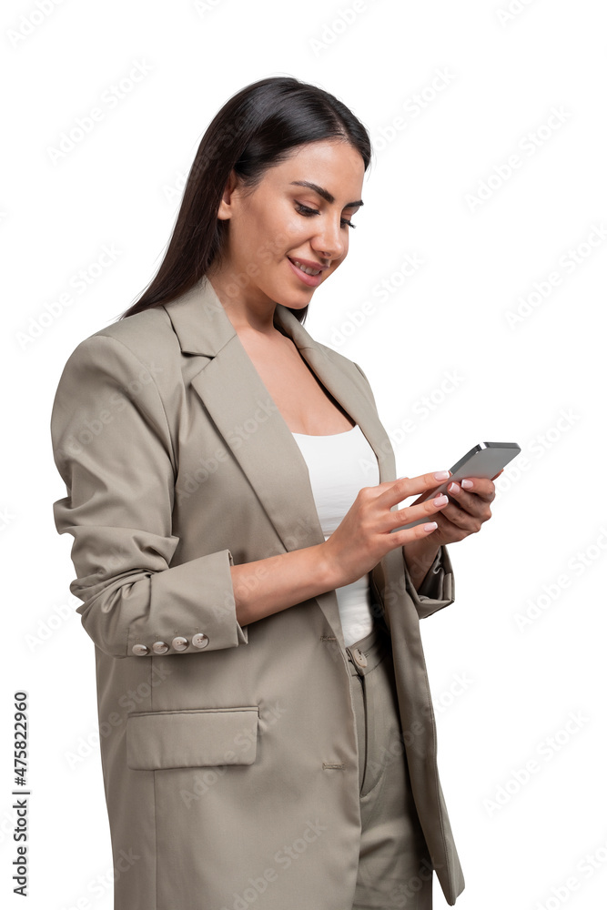 Smiling young attractive businesswoman wearing formal suit is holding smartphone Smiling young attractive businesswoman wearing formal suit is holding smartphone