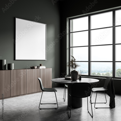 Dark guest room interior with chairs and table, window and mockup poster