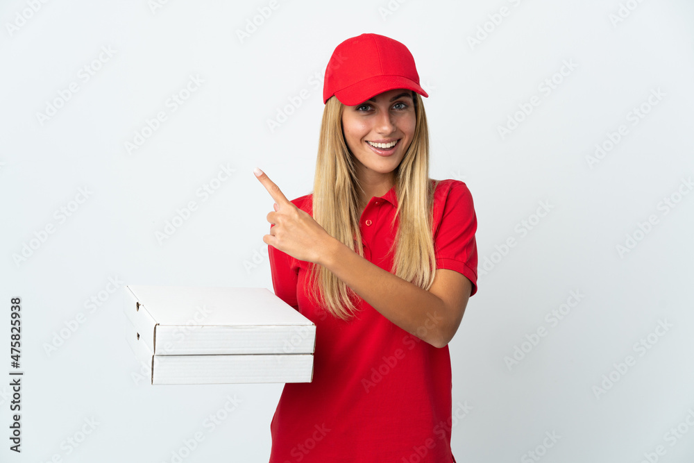 Pizza delivery woman holding a pizza isolated on white background pointing to the side to present a product Pizza delivery woman holding a pizza isolated on white background pointing to the side to present a product