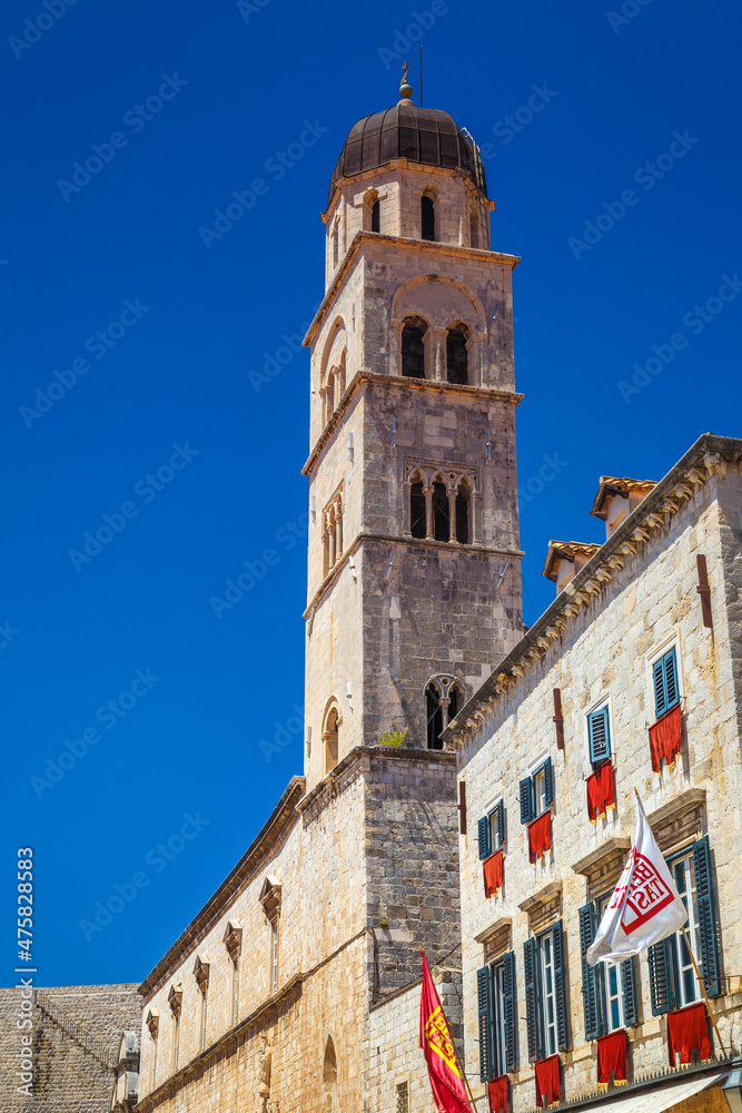 Tower of Franciscan Church and Monastery on Stradun street in the historic city center of Dubrovnik in Croatia, Europe.