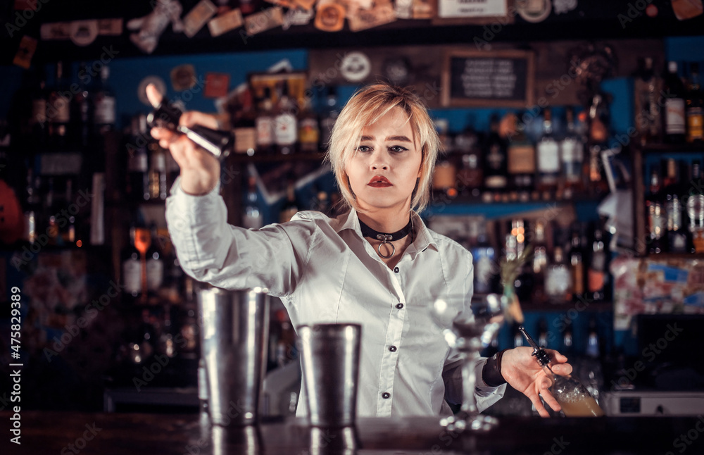 Girl barman makes a cocktail at the brasserie Girl barman makes a cocktail at the brasserie
