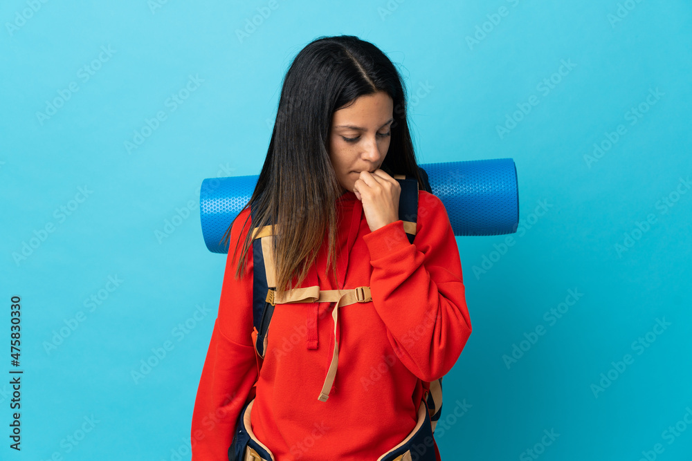 Young mountaineer woman with backpack having doubts Young mountaineer woman with backpack having doubts