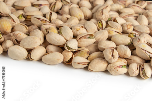 Roasted and salted pistachios in shell on white background copy space