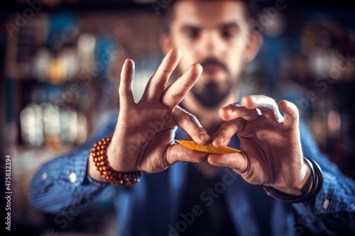 Portrait of barman makes a show creating a cocktail at the night club photo