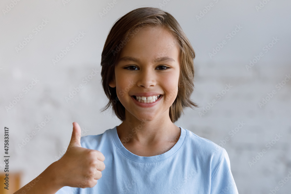 Head shot portrait sincere little male teenage client with wide whitening toothy smile showing thumbs up gesture, feeling excited of professional dental services, positive recommendation concept. Head shot portrait sincere little male teenage client with wide whitening toothy smile showing thumbs up gesture, feeling excited of professional dental services, positive recommendation concept.