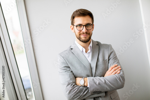 Young modern businessman st...