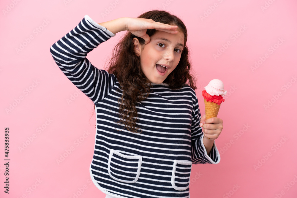 Little caucasian girl holding an ice cream isolated on pink background with surprise expression Little caucasian girl holding an ice cream isolated on pink background with surprise expression