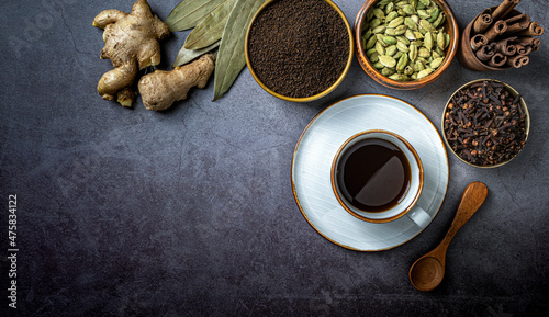 Top view of a cup of coffee and Indian seasonings on a table