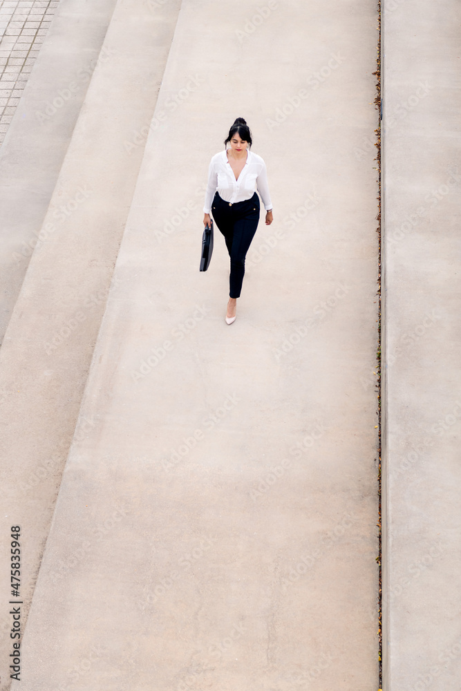 businesswoman walking on a concrete floor