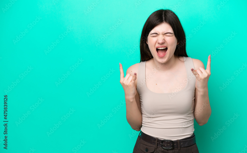 Fototapeta premium Young Russian woman isolated on green background making horn gesture