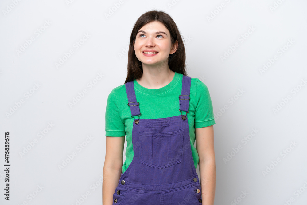 Young Russian woman isolated on blue background thinking an idea while looking up