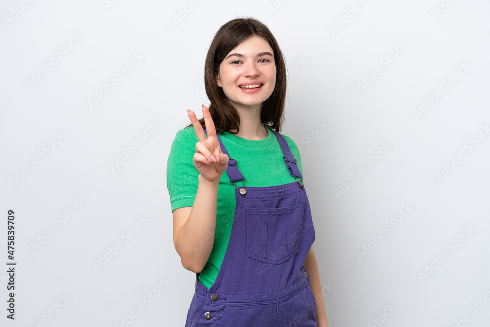 Young Russian woman isolated on blue background smiling and showing victory sign Young Russian woman isolated on blue background smiling and showing victory sign