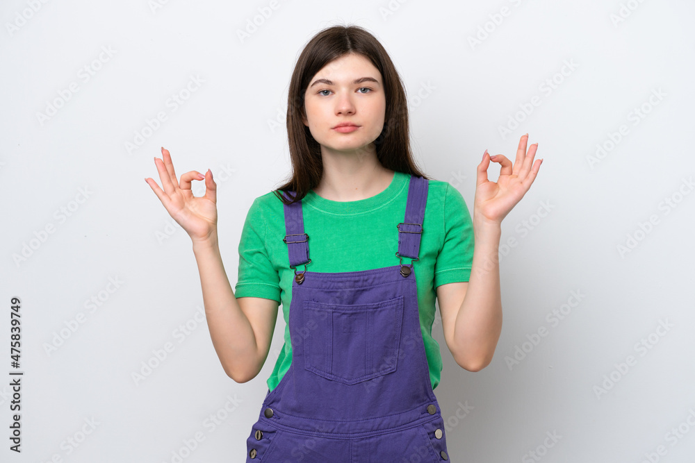 Young Russian woman isolated on blue background in zen pose Young Russian woman isolated on blue background in zen pose
