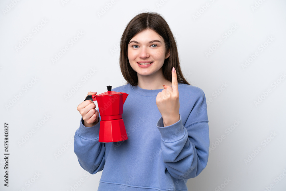 Young Russian woman holding coffee pot isolated on white background doing coming gesture Young Russian woman holding coffee pot isolated on white background doing coming gesture