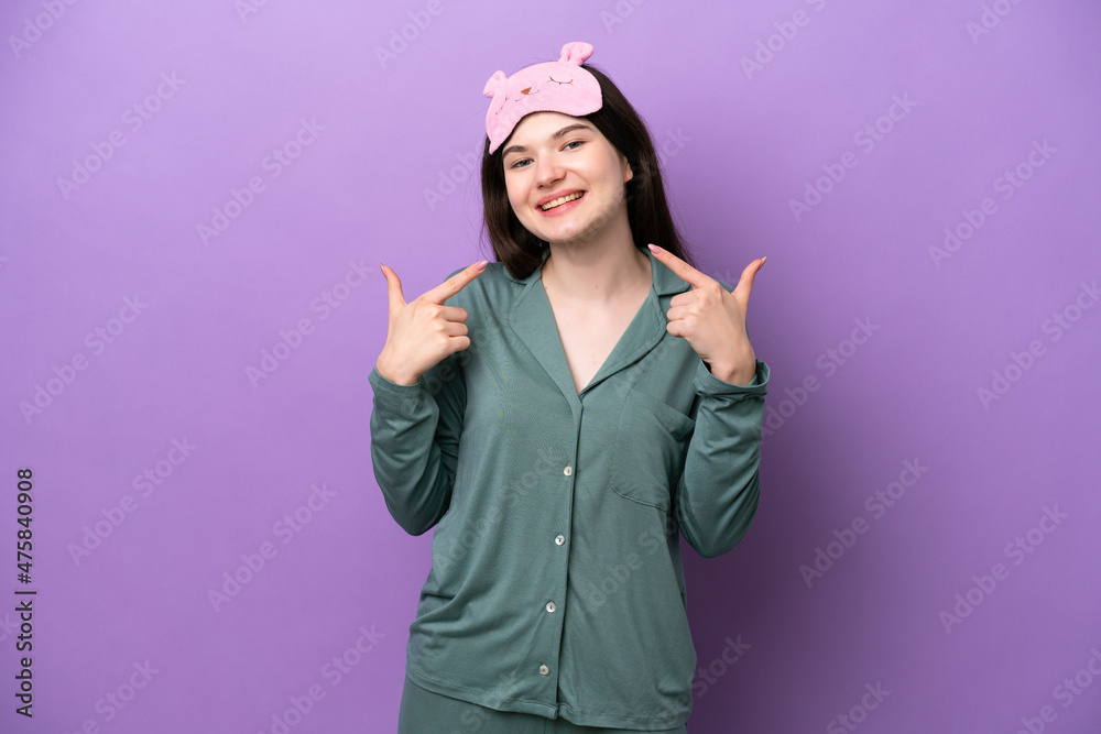 Young Russian woman in pajamas isolated on purple background giving a thumbs up gesture Young Russian woman in pajamas isolated on purple background giving a thumbs up gesture