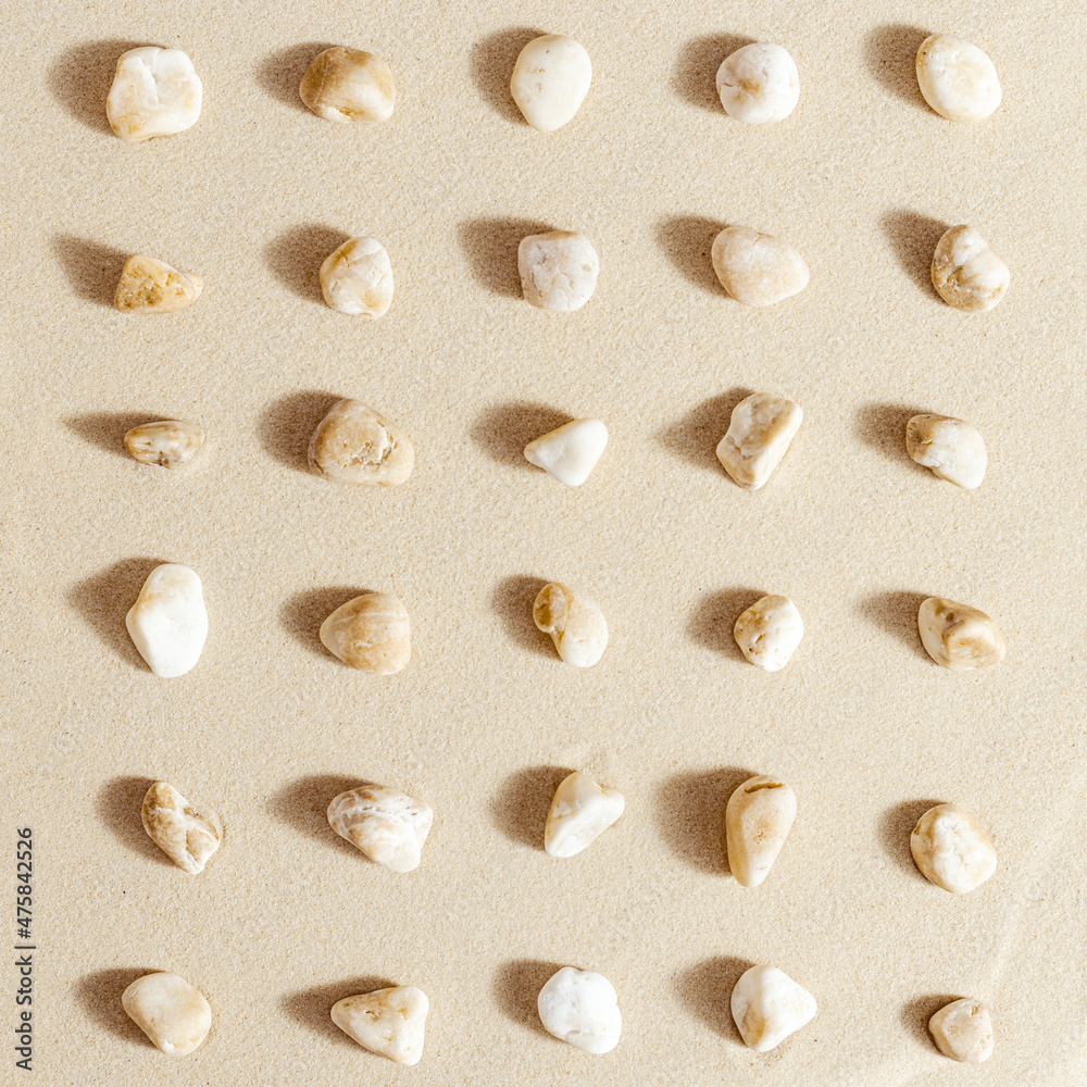 Pattern with close up pebble sea stones on sand texture. Layout from natural stone neutral natural tones. Minimal style sandy background Pattern with close up pebble sea stones on sand texture. Layout from natural stone neutral natural tones. Minimal style sandy background