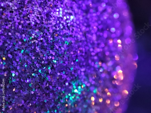 Very Peri background, Christmas ball color Very Peri, glitter background color Very Peri, color trend 2022, garland and Christmas ball Very Peri, selective focus