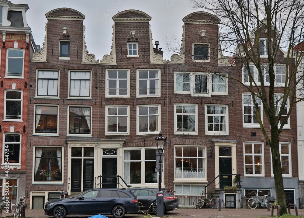 Amsterdam Traditional Canal House Facades with Three Neck Gables and Charging Electric Car, Netherlands