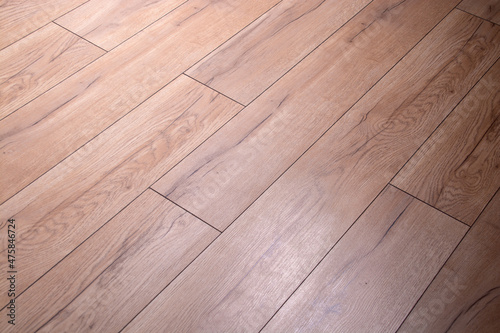 brown parquet board with rough texture and illumination.