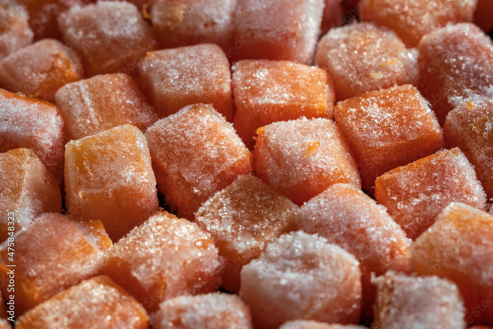 Frozen fresh carrot cube pieces closeup background Frozen fresh carrot cube pieces closeup background