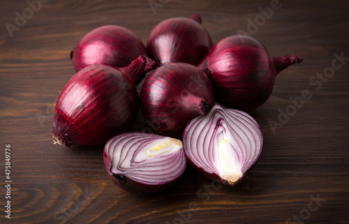 Organic red onions on a wooden background  fresh raw vegetables.
