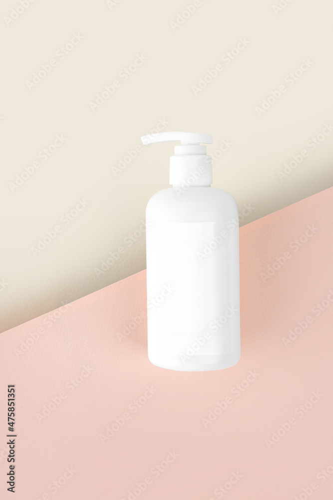 Natural Hypoallergenic Foam for bathing children. White Plastic pump bottle. children's cosmetics. Bottles on a beige pink background. Vertical. Copy space Natural Hypoallergenic Foam for bathing children. White Plastic pump bottle. children's cosmetics. Bottles on a beige pink background. Vertical. Copy space