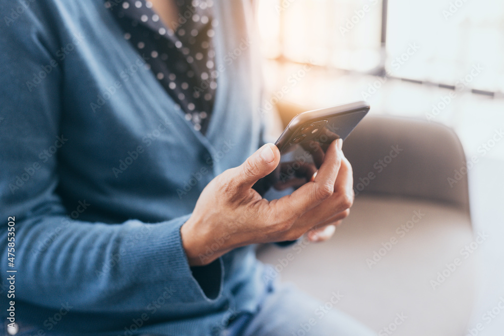 using cell phone hand holding mobile texting message contact us.chatting,search internet information in office.technology device communication connecting using cell phone hand holding mobile texting message contact us.chatting,search internet information in office.technology device communication connecting