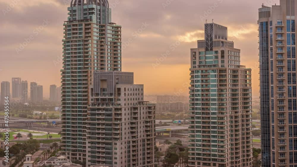 Sunrise over Dubai Marina luxury tourist district with skyscrapers and towers around canal aerial timelapse Sunrise over Dubai Marina luxury tourist district with skyscrapers and towers around canal aerial timelapse