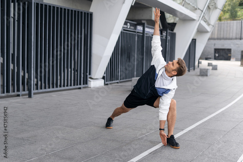 Sporty young athlete making yoga training outdoors