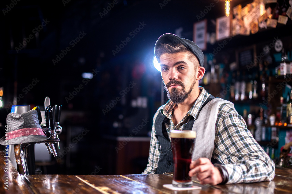 Professional bartender is pouring a drink in the bar
