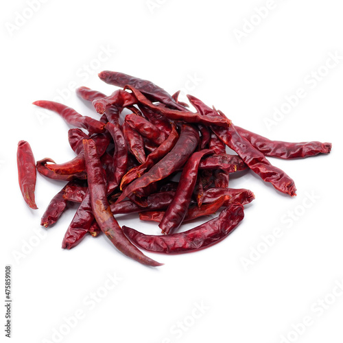 Pile of red dried chilli on white background. It's ingredient for Asian curry paste, chili sauce and many kind of sauce. Spot Focus.