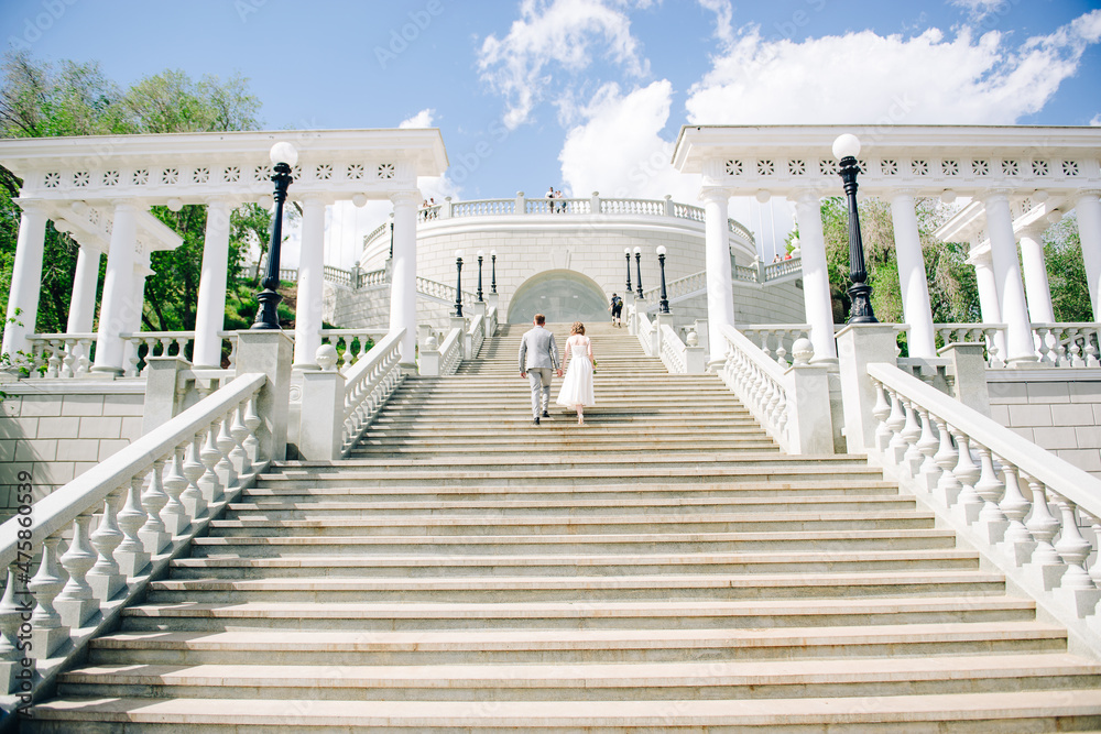 Fototapeta premium young couple in love holding hands and looking into the distance