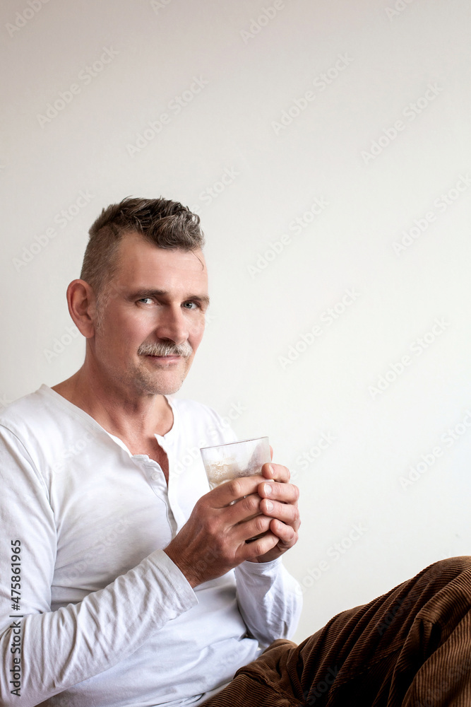 handsome man in his 50s drinking ccoffee handsome man in his 50s drinking ccoffee