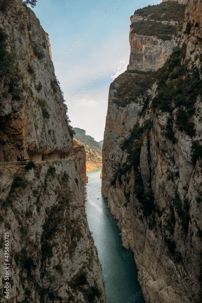A high gorge of rocks and a mountain river. Deep narrow canyon along the river.
