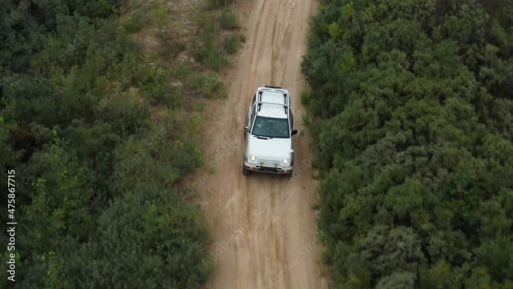 Aerial view of a car driving on sand Aerial view of a car driving on sand