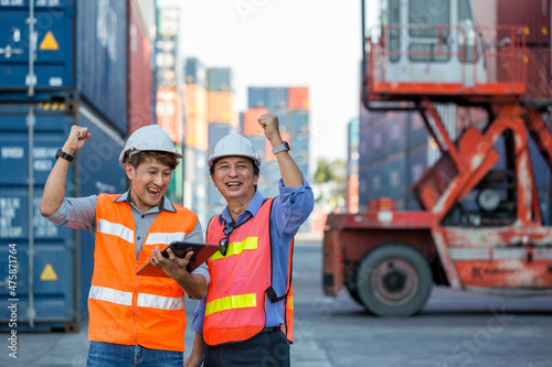 Container cargo foreman partners successful happy together into container for loading. Celebrating success. Group of worker looking happy at their working places in container cargo site